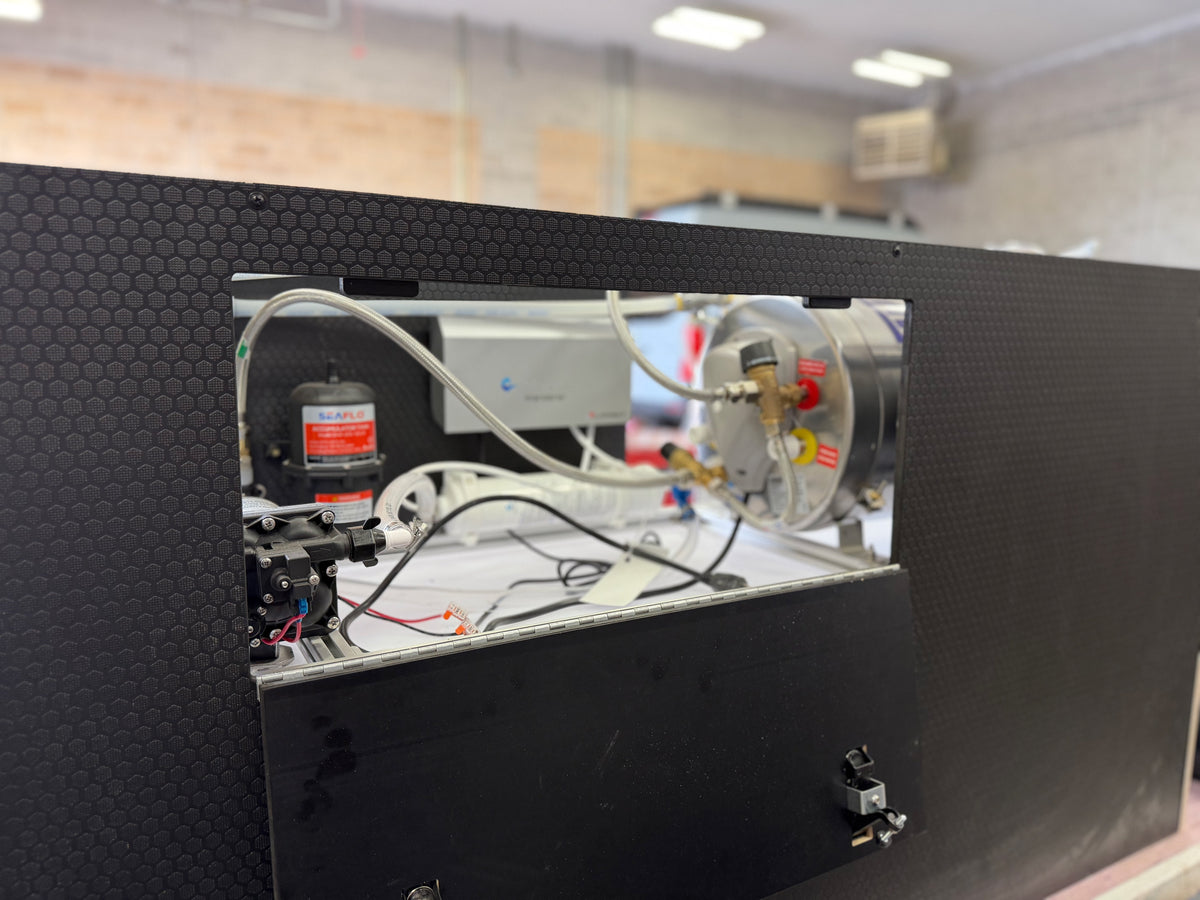 Plumbing cabinet open — HexPly door, heater, SEAFLO
